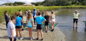 Kids stnasing on a shore