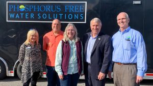Five people standing infront of a trailer with a Phosphorus Free Water Solutions sign
