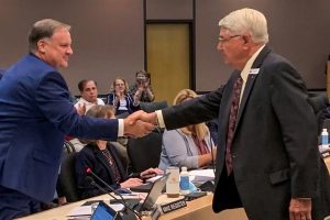 Mike Register shaking hands with Douglas Burnett