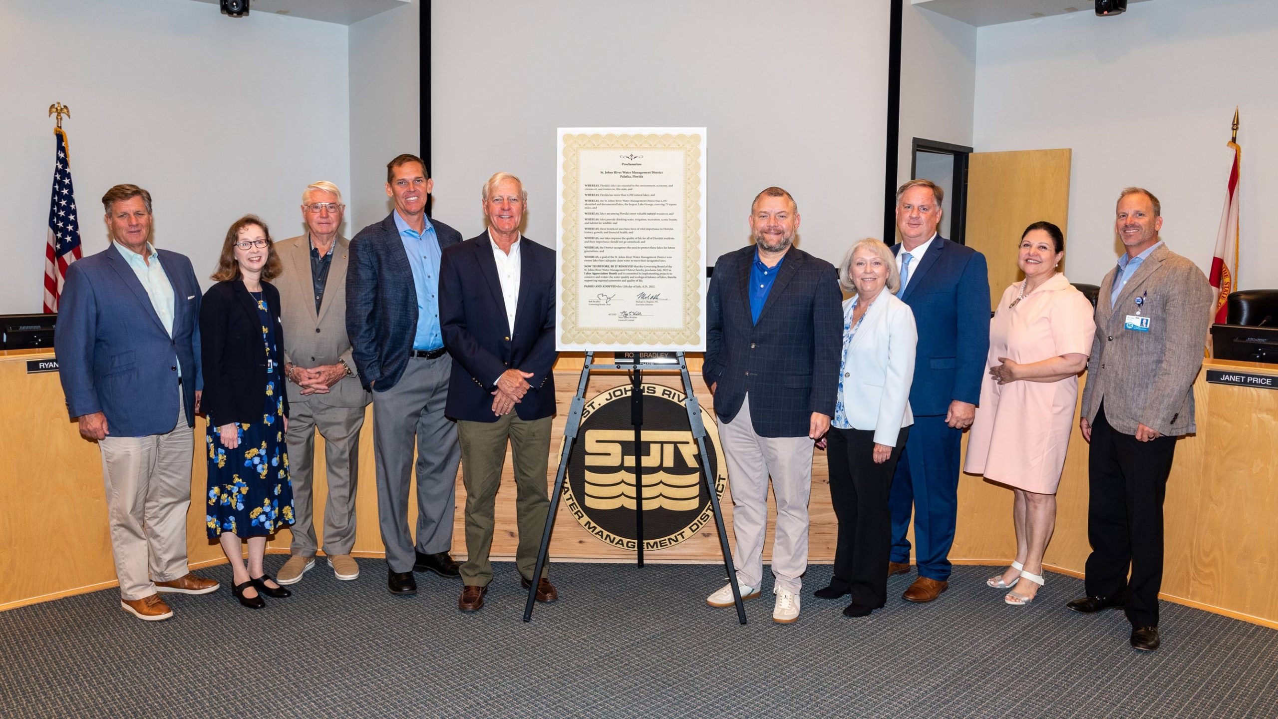 Board members taking a picture with several other people