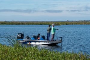Fishermen fishing off the side of a boat