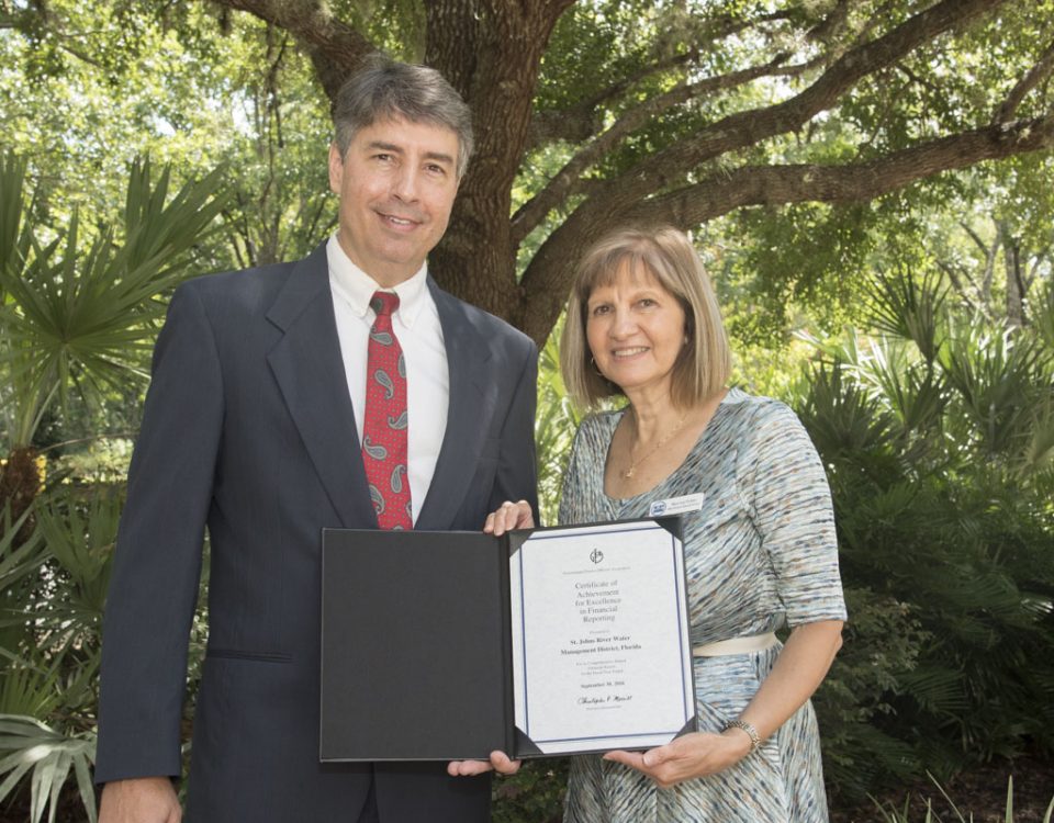 Mary-Lou Pickles and Greg Rockwell with a finance award