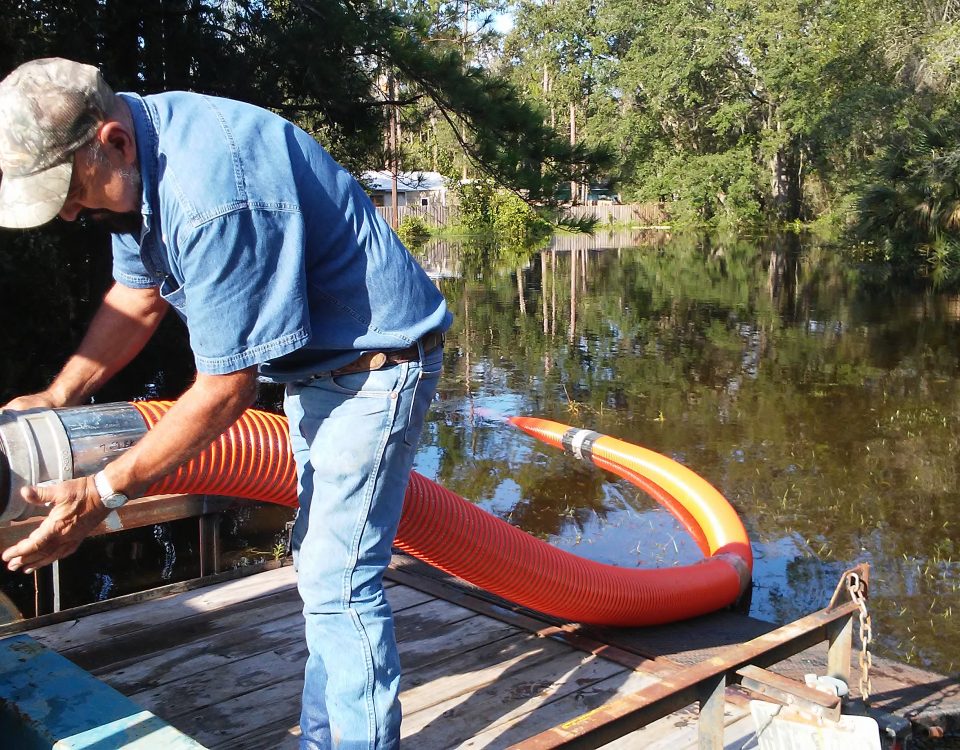 District staff connecting up a pump to alleviate flooding