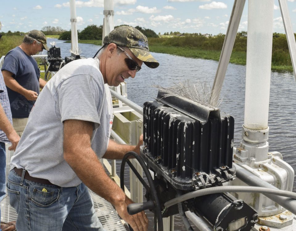 District staff opening gates on water control structure