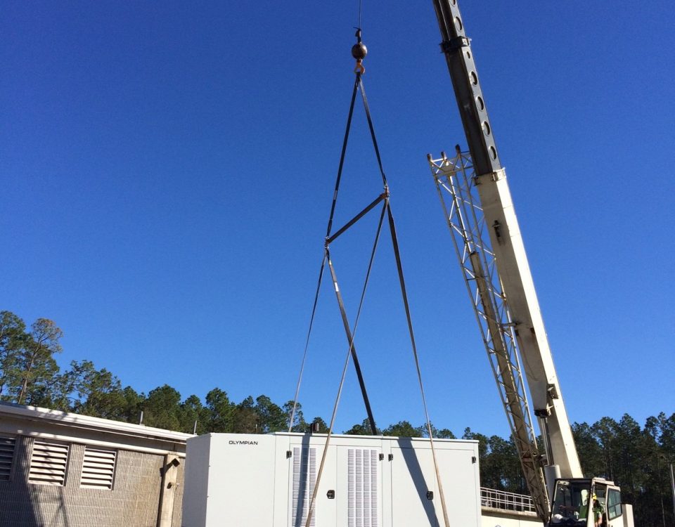 Crane lifting a large generator during installation at Palatka wastewater treatment plant