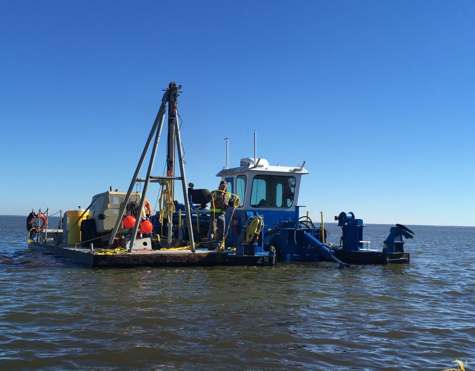 Perople working on a dredging barge on Lake Apopka