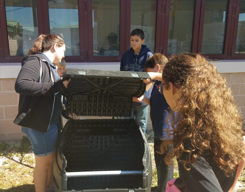 Students installing a composter at their school