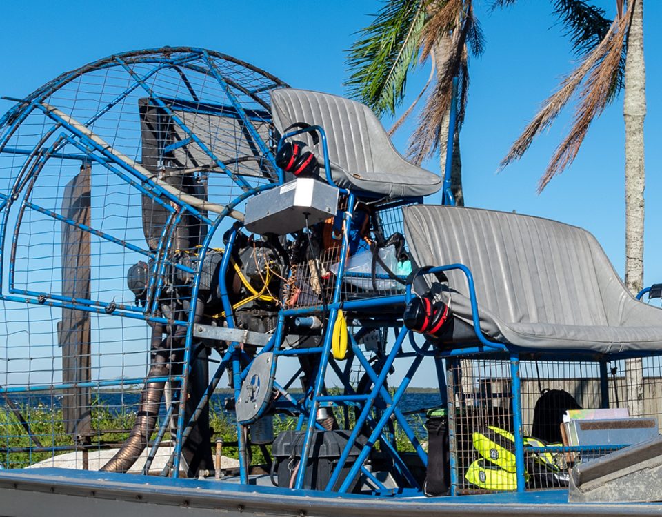 Airboat sitting along a water body