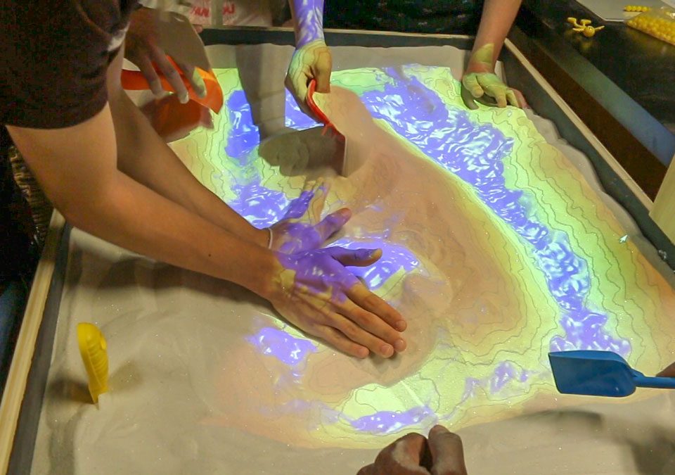 Students interacting with a science exhibit