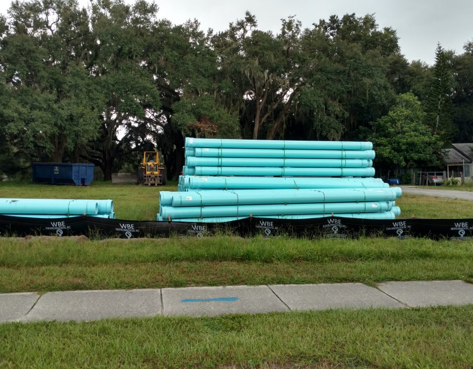 Stacks of large water pipes in a field