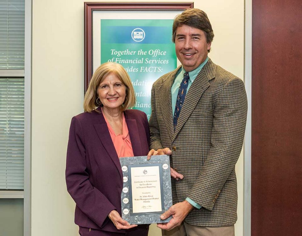 Mary-Lou Pickles and Greg Rockwell with a finance award