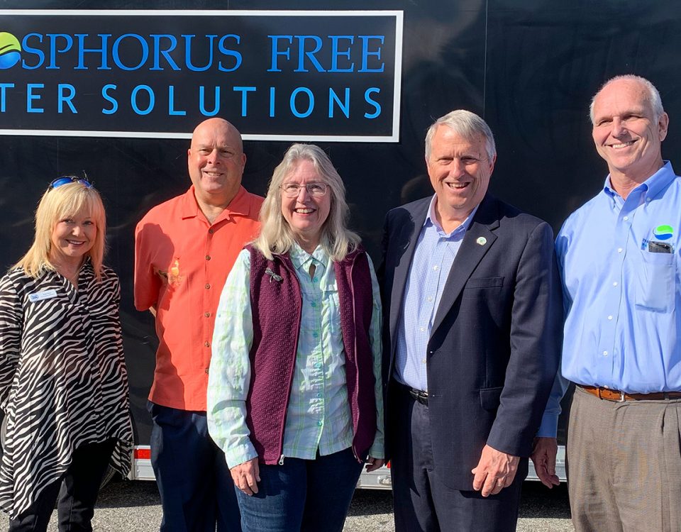 Five people standing infront of a trailer with a Phosphorus Free Water Solutions sign