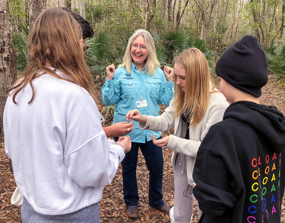 Dr. Ann Shortelle with students in the woods