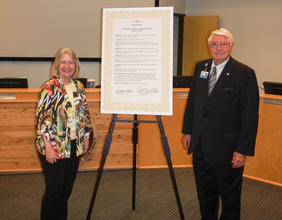 Dr. Ann Shortelle and Gen. Douglas Burnett standing next to a signed proclamation