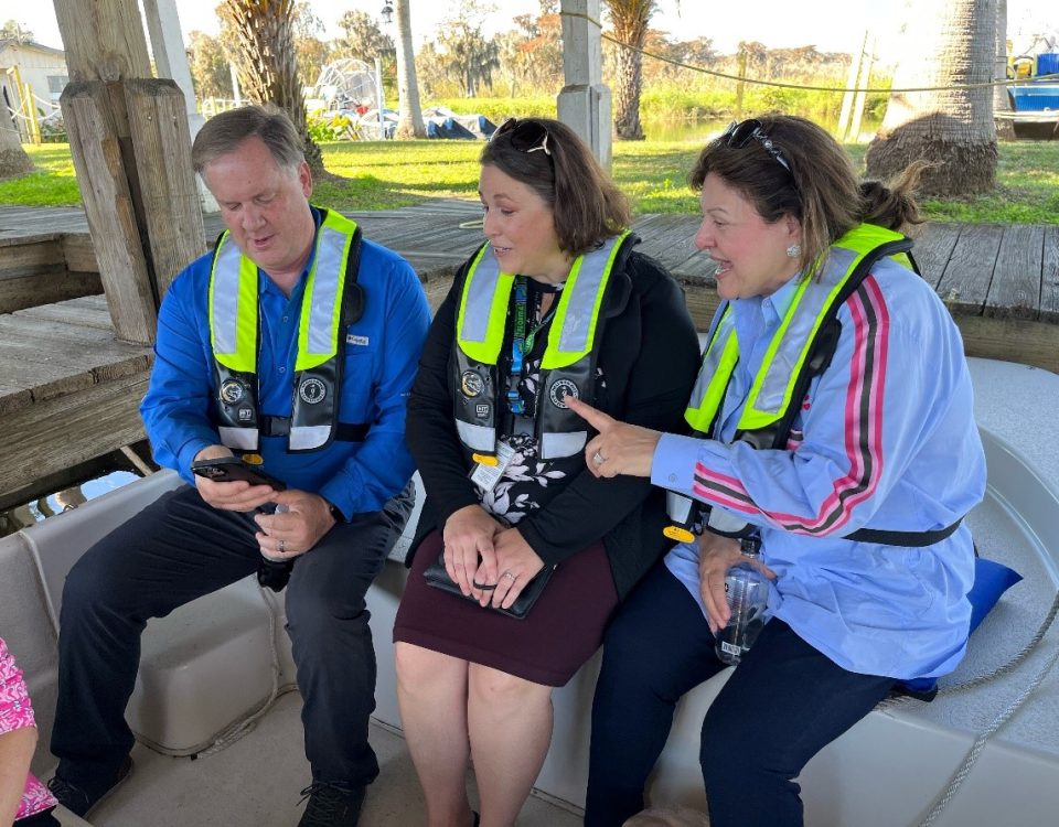 Mike Register sitting next to two women