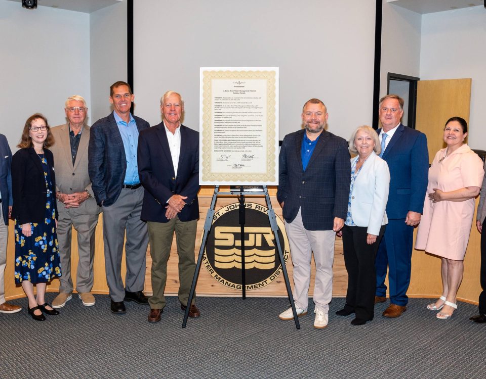 Board members taking a picture with several other people