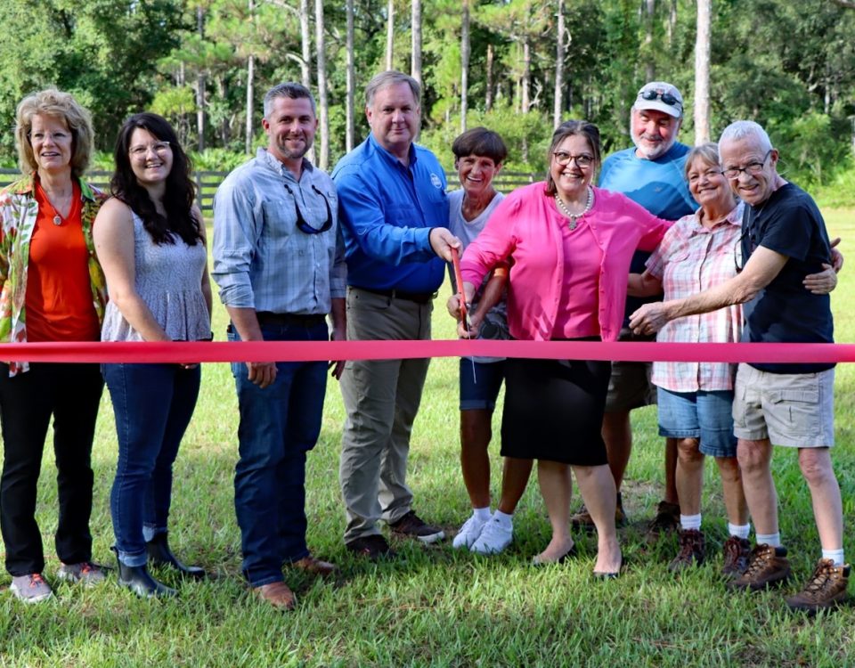 Group of people cutting a ribbom