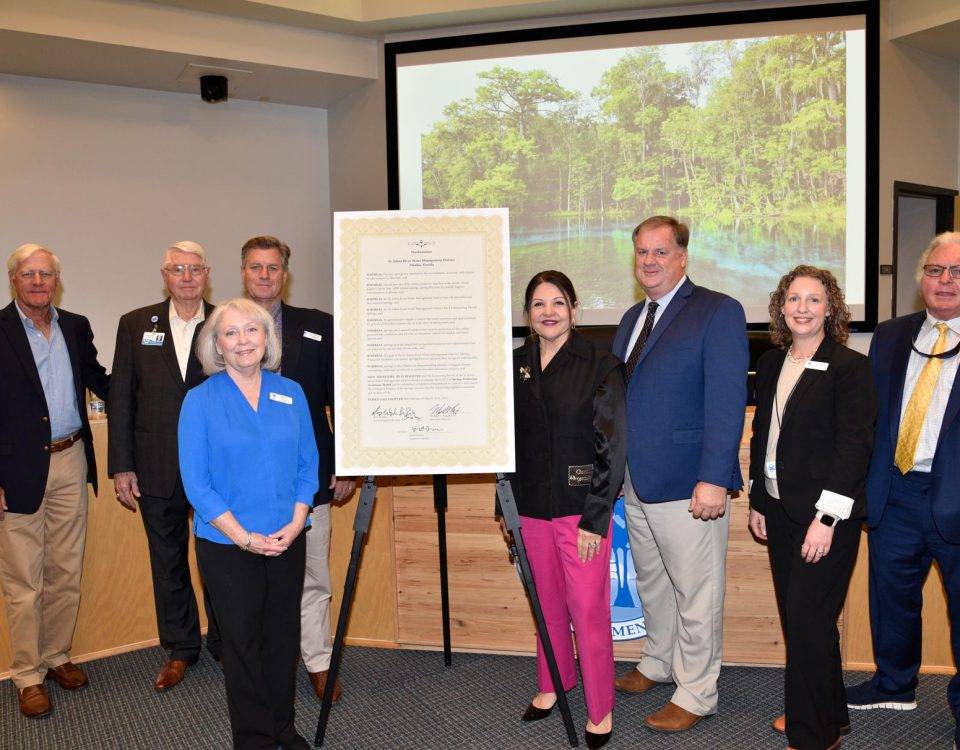 Board members standing by a proclamation