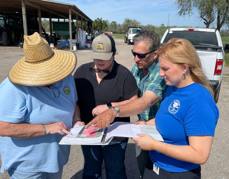 People having a discussion out on a farm